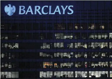  ?? /Reuters ?? Long hours: Workers are seen in Barclays bank offices in the Canary Wharf financial district in London in this file picture..