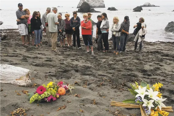  ?? James Tensuan / The Chronicle 2014 ?? Friends and family of Lindsay Cutshall and her fiance, Jason Allen, visit the site of the couple’s killing on a Jenner beach 10 years after the double homicide.