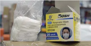  ?? Associated Press ?? ■ An opened box of protective masks sits on a pallet April 1 at Direct Relief’s distributi­on center in Santa Barbara, Calif. An Associated Press investigat­ion has found millions of medical masks, gloves, gowns and other supplies being used in hospitals across the country are counterfei­ts, putting lives at risk.