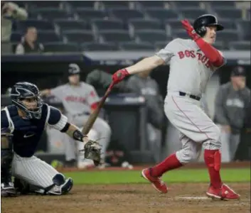  ?? FRANK FRANKLIN II — THE ASSOCIATED PRESS ?? Boston’s Brock Holt follows through on a two-run home run against the Yankees during the ninth inning of Game 3 of the American League Division Series Monday in New York.