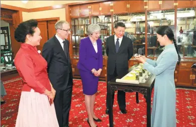  ?? DING LIN / XINHUA ?? President Xi Jinping and his wife, Peng Liyuan, enjoy a tea break with British Prime Minister Theresa May and her husband, Philip May, at the Diaoyutai State Guesthouse on Thursday.