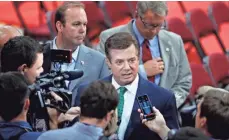  ?? J. SCOTT APPLEWHITE/AP ?? Paul Manafort, center, and Rick Gates, left, pleaded not guilty Monday in federal court to charges of conspiracy and money laundering filed by special counsel Robert Mueller.