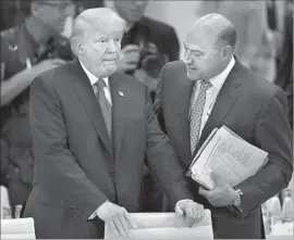  ?? Michael Sohn Associated Press ?? GARY COHN, right, and President Trump at the G20 summit in July. Cohn, who is Jewish, criticized the president’s response to the violence in Charlottes­ville, Va.