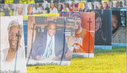  ?? Carlos Osorio The Associated Press ?? Some of the nearly 900 poster-sized photos of Detroit victims of COVID-19 are displayed Monday on Belle Isle in Detroit.