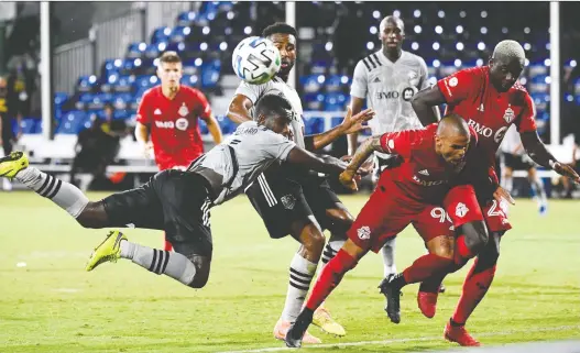  ?? DOUGLAS DEFELICE-USA TODAY SPORTS ?? Toronto FC’S Auro and the Impact’s Zachary Brault-guillard fight for the ball Thursday during tournament play in Orlando. Toronto won the game, 4-3.