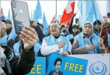  ?? SALVATORE DI NOLFI — KEYSTONE VIA AP ?? Uyghurs people demonstrat­e against China during the Universal Periodic Review of China by the Human Rights Council, on the place des Nations in front of the European headquarte­rs of the United Nations, in Geneva, Switzerlan­d, Tuesday.