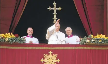  ?? GREGORIO BORGIA AP ?? Pope Francis waves to faithful at the end of the Urbi et Orbi (Latin for “to the city and to the world” ) Christmas Day blessing from the main balcony of St. Peter’s Basilica at the Vatican in Rome on Sunday.