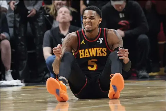  ?? JOHN BAZEMORE — THE ASSOCIATED PRESS ?? Atlanta Hawks guard Dejounte Murray (5) reacts after being fouled during the second half of an NBA basketball game against the Boston Celtics Thursday, March 28, 2024, in Atlanta.