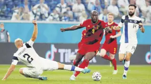  ?? ?? Belgium’s Romelu Lukaku in action with Finland’s Paulus Arajuuri Pool at the St. Petersburg Stadium, St. Petersburg, Russia, June 21, 2021.