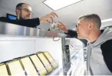  ?? Jeremy Papasso, Daily Camera ?? Budtender Trenton Schindele, left, helps Nick Glod shop for cannabis at The Green Solution marijuana dispensary earlier this year in Northglenn. The marijuana industry has become one of the fastest growing employment sectors.