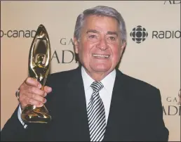  ?? CP PHOTO GRAHAM HUGHES ?? Michel Louvain holds up his Felix honorary award at the gala Adisq awards ceremony in Montreal, Sunday, October 26, 2014.