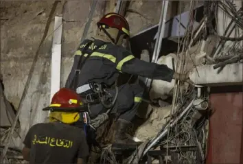  ?? Sam Tarling/ Getty Images ?? Rescue workers return to search a destroyed building with the aim of finding a potential survivor Thursday in the aftermath of the Aug. 4 blast in Beirut. A sniffer dog with a Chilean rescue crew responded to the presence of a person in the rubble.