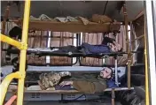  ?? RUSSIAN DEFENSE MINISTRY PRESS SERVICE VIA AP ?? Wounded Ukrainian servicemen lay in a bus as they are being evacuated from the besieged Azovstal steel plant in Mariupol, Ukraine, as shown in a photo taken from video released by the Russian Defense Ministry Press Service on Tuesday.