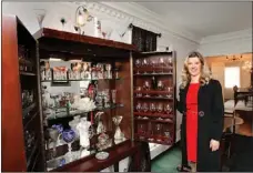  ?? McClatchey Newspapers Photos ?? Allison Perley-Harter stands in her home next to her glass collection.