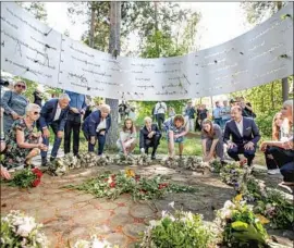  ?? Beate Oma Dahle Norwegian News Agency ?? NORWEGIAN OFFICIALS and members of the royal family lay f lowers at a memorial service Thursday for the 77 killed by an extremist on July 22, 2011.