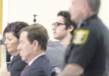  ?? ERIC HASERT AP ?? Austin Harrouff, in back, sits with his legal team before Circuit Judge Sherwood Bauer in Martin County. Harrouff was found not guilty by reason of insanity Monday for killing a Martin County couple and injuring a third person.