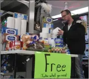  ?? NEWS PHOTO MO CRANKER ?? Animal World owner Rob Andreas stocks up a table of free supplies he is hosting at his business. He is asking anyone in need of a few basic supplies to swing by his store and take what they need, no questions asked.