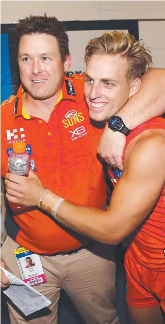  ?? Picture: GETTY ?? Darcy Macpherson celebrates with coach Stuart Dew after beating the Bulldogs.