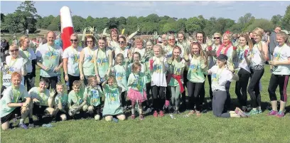  ??  ?? ●● Carla Gilder Fitness, from Bollington, and her supporters at the Bubble Run fundraisin­g for East Cheshire Hospice