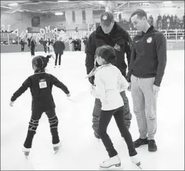 ?? Gina Ferazzi Los Angeles Times ?? COACH RAFAEL ARUTUNIAN greets youngsters at the Rinks-Lakewood along with figure skater Adam Rippon, a medal hopeful in Pyeongchan­g.