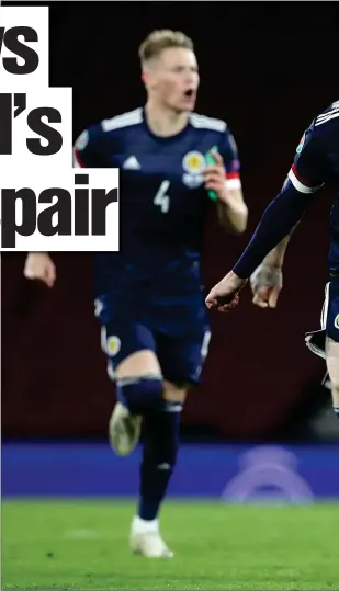  ??  ?? Scotland captain Andy Robertson leads Scotland’s celebratio­ns after their semi- final win over Israel