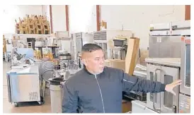  ?? TERRY CHEA/AP ?? Jose Bonilla Jr. shows a used industrial oven for sale last month at his family’s business, American Restaurant Supply in San Leandro, California. The COVID-19 pandemic has forced thousands of restaurant­s nationwide to permanentl­y shut their doors.