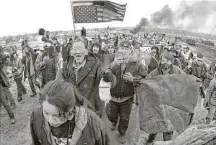  ?? Mike McCleary / Bismarck Tribune file ?? Dakota Access pipeline protesters march out of their camp in February before the deadline set for evacuation by the U.S. Army Corps of Engineers.