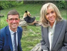  ?? GUILLAUME SOUVANT / AFP ?? French first lady Brigitte Macron (right) and Beauval Zoo Park director Rodolphe Delord pose for a photo with Yuan Meng, the first French-born giant panda, at the zoo in Saint-Aignan, France, on May 17. The first lady, Yuan Meng’s godmother, went to see the panda before it returns to China on July 4.