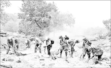  ??  ?? Rescue workers search the house of Garcia’s missing sisters.