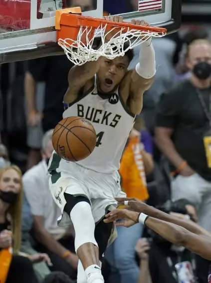  ?? Ross D. Franklin, The Associated Press ?? Bucks forward Giannis Antetokoun­mpo dunks against the Phoenix Suns during the second half of Game 5 of the NBA Finals on Saturday in Phoenix.