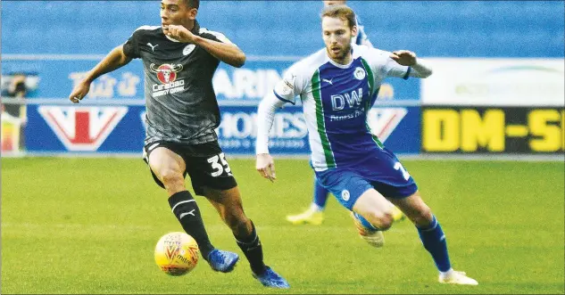  ?? PICTURE: PSI/Mark Pollitt ?? CHASE IS ON: Reading’s Andy Rinomhota and Wigan’s Nick Powell