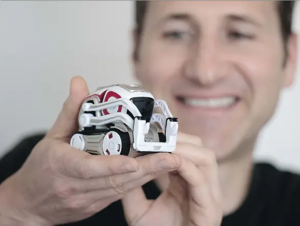  ?? PETER J. THOMPSON ?? Patrick De Neale, Anki’s vice-president of business developmen­t and corporate strategy, holds AI-inspired robot, Cozmo, a U.S. hit now available at BestBuy in Canada.