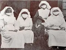  ??  ?? Nurses and a Scout helper at the Ma¯ori Hospital in Temuka. Ma¯ori suffered a death rate eight times that of the general population.