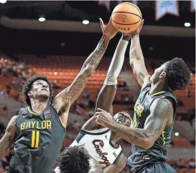  ?? NATHAN J FISH/THE OKLAHOMAN ?? OSU’s Moussa Cisse (33) fights for a rebound against Baylor’s Jalen Bridges (11) and Baylor guard Langston Love (13) in the first half Monday at Gallagher-Iba Arena in Stillwater.