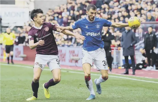  ??  ?? 2 Aaron Hickey tussles with Borna Barisic during Hearts’ 1-1 draw with Rangers at Tynecastle last October.