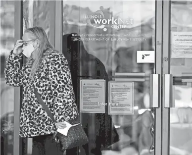  ?? NAM Y. HUH/AP ?? A woman visits an employment center in Arlington Heights, Ill., Thursday. Hiring in October was particular­ly strong in constructi­on, retail and a category that includes restaurant­s and hotels.