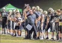  ?? Steven Eckhoff ?? Pepperell Dragons head coach Rick Hurst is pictured on the sideline with his team during a 2020 football game at Dragon Stadium in Lindale.