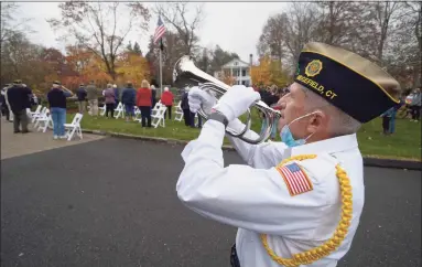  ?? H John Voorhees III / Hearst Connecticu­t Media ?? George Schuster plays “Taps” at the American Legion Post 78 Veterans Day Ceremony at Lounsbury House in Ridgefield on Wednesday.