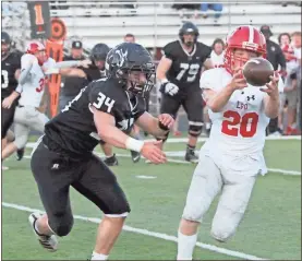  ?? Scott Herpst ?? LFO’S Gabe Helton keeps his eye on the ball as he completes a juggling intercepti­on in front of Ridgeland’s Jonathan Woodall during Friday night’s scrimmage in Rossville.