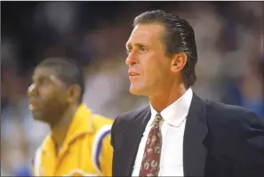  ?? MIKE POWELL/GETTY IMAGES ?? Los Angeles Lakers head coach Pat Riley on the sideline in front of Magic Johnson during an NBA game at the Great Western Forum in Los Angeles in 1988.