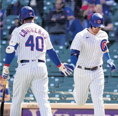  ?? BY NUCCIO DINUZZO/GETTY PHOTO ?? Ian Happ, right, is congratula­ted by Willson Contreras following his home run against the Pittsburgh Pirates during the third inning on Sunday.