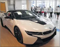  ?? AP PHOTO ?? Voters cast their ballots in the showroom of a BMW dealership Tuesday, in Los Angeles.