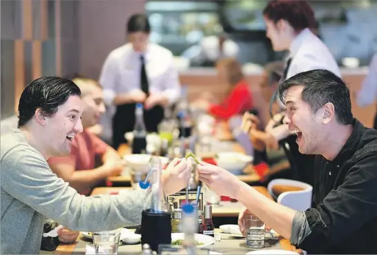  ?? Christina House For The Times ?? JOSEPH ISAACS, left, and Ryan Graber eat at the Tsujita in Glendale. The well-regarded Tokyo noodle shop first came to L.A. six years ago, on Sawtelle Boulevard.