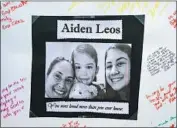  ??  ?? A PHOTO of Aiden Leos hangs at the memorial. The boy died in his mother’s arms, according to a relative.