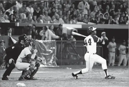  ?? Associated Press ?? The Braves’ Hank Aaron breaks Babe Ruth’s record for career home runs as he hits his 715th off Dodgers pitcher Al Downing in the fourth inning on April 8, 1974. Aaron died peacefully in his sleep early Friday.