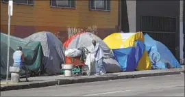 ?? Mel Melcon Los Angeles Times ?? HOMELESS camps, like this one in downtown Los Angeles, make conditions “ideal” for an increase in rats, which carry typhus, an expert says.