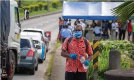  ??  ?? Security officers check cars along a road in Suva after the Fijian capital entered a 14-day lockdown after a leak from a quarantine facility and a funeral caused Covid-19 to spread in the community. Photograph: Leon Lord/AFP/Getty Images