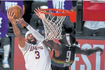  ?? AAron Ontiveroz, The Denver Post ?? The Lakers’ Anthony Davis takes it to the hoop against the Nuggets’ Jerami Grant on Tuesday. “I like Jerami Grant guarding Anthony Davis,” coach Michael Malone said.