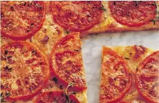  ??  ?? Tomato Phyllo Pizza’s layered phyllo crust is a bit more finicky than standard pizza dough, but its crispy, flaky, cheesy deliciousn­ess is worth it.