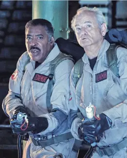  ?? ?? Winston (Ernie Hudson, left) and Peter (Bill Murray) are back in the old uniforms in “Ghostbuste­rs: Frozen Empire.”